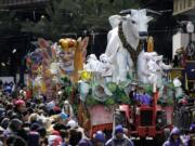 The Krewe of Rex parade rolls through downtown New Orleans last year on Mardi Gras in New Orleans. Mardi Gras this year falls on Feb. 9.