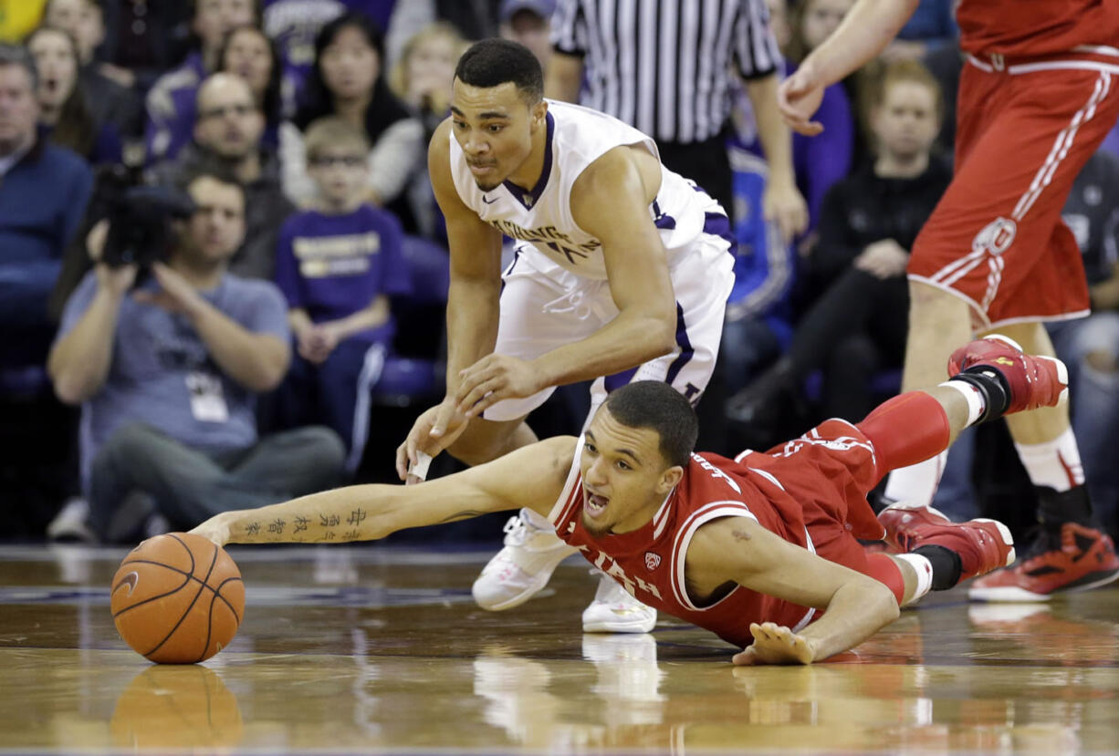 Utah&#039;s Brekkott Chapman, right, dives for a loose ball as Washington&#039;s Andrew Andrews closes in on the play.