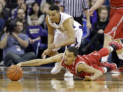 Utah&#039;s Brekkott Chapman, right, dives for a loose ball as Washington&#039;s Andrew Andrews closes in on the play.