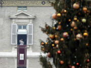 Pope Francis delivers his blessing from his studio&#039;s window during the Angelus prayer in St. Peter&#039;s Square at the Vatican on Friday. Welcoming the new year Friday, Pope Francis called for an end to the ??arrogance of the powerful?? relegating the weak to squalid outskirts of society and to the ??false neutrality?? to conflicts, hunger and persecution triggering a sometimes-deadly exodus of refugees.