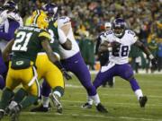 Minnesota Vikings' Adrian Peterson runs during the second half an NFL football game against the Green Bay Packers Sunday, Jan. 3, 2016, in Green Bay, Wis.