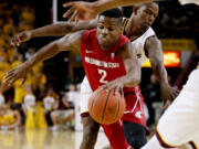 Washington State guard Ike Iroegbu (2) drives past Arizona State guard Gerry Blakes during the first half of an NCAA college basketball game Thursday, Jan. 14, 2016, in Tempe, Ariz.