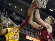 Washington State forward Josh Hawkinson, right, battles Southern California guard Julian Jacobs (12) for a rebound during the first half of an NCAA college basketball game in Los Angeles, Thursday, Jan. 28, 2016.