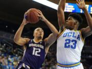 Washington's Andrew Andrews (12) goes to the hoop against UCLA's Tony Parker in the first half of an NCAA college basketball game in Los Angeles, Thursday, Jan. 28, 2016.