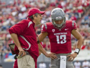 Washington State head coach Mike Leach gives instructions to backup quarterback Cody Clements during the Crimson and Gray game in Spokane on Saturday.