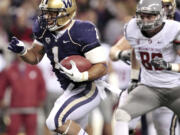 Washington's Chris Polk (1) runs for a portion of his 100 yards against Washington State on Saturday.