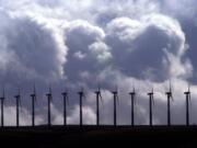 Wind turbines spin  under wind swept, cloudy skies along a ridge line in the Columbia River Gorge at FPL Energy's Stateline Wind Project on the Oregon-Washington border near Touchet, Wash., March 6, 2003.