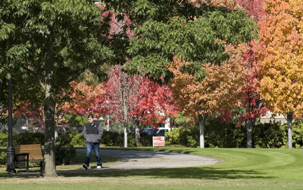 A pedestrian walks through Marine Park, near the Columbia River waterfront.