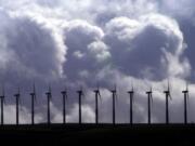 Wind turbines spin under cloudy skies along a ridge line in the Columbia River Gorge at FPL Energy's Stateline Wind Project on the Oregon-Washington border near Touchet on March 6, 2003. Washington's Energy Facility Site Evaluation Council recommended Thursday that Gov.