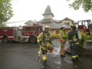 Vancouver firefighters work to contain a fire that broke out at Who Song &amp; Larry's restaurant Monday.