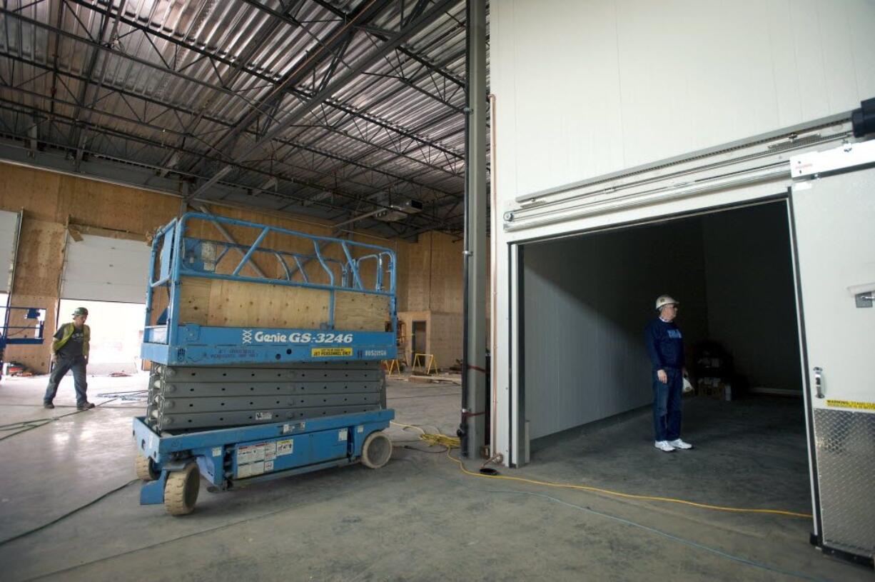 Joe Pauletto, right, stands inside the walk-in refrigerator while giving a tour of the site of the new Clark County Food Bank on September 30. It is still under construction, but scheduled to open before the end of the year.