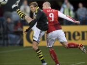 Portland's Kris Boyd (9) gets a header past Sweden's AIK defender Per Karlsson and then the goaltender for the game's only goal at Jeld-Wen Field on Sunday.