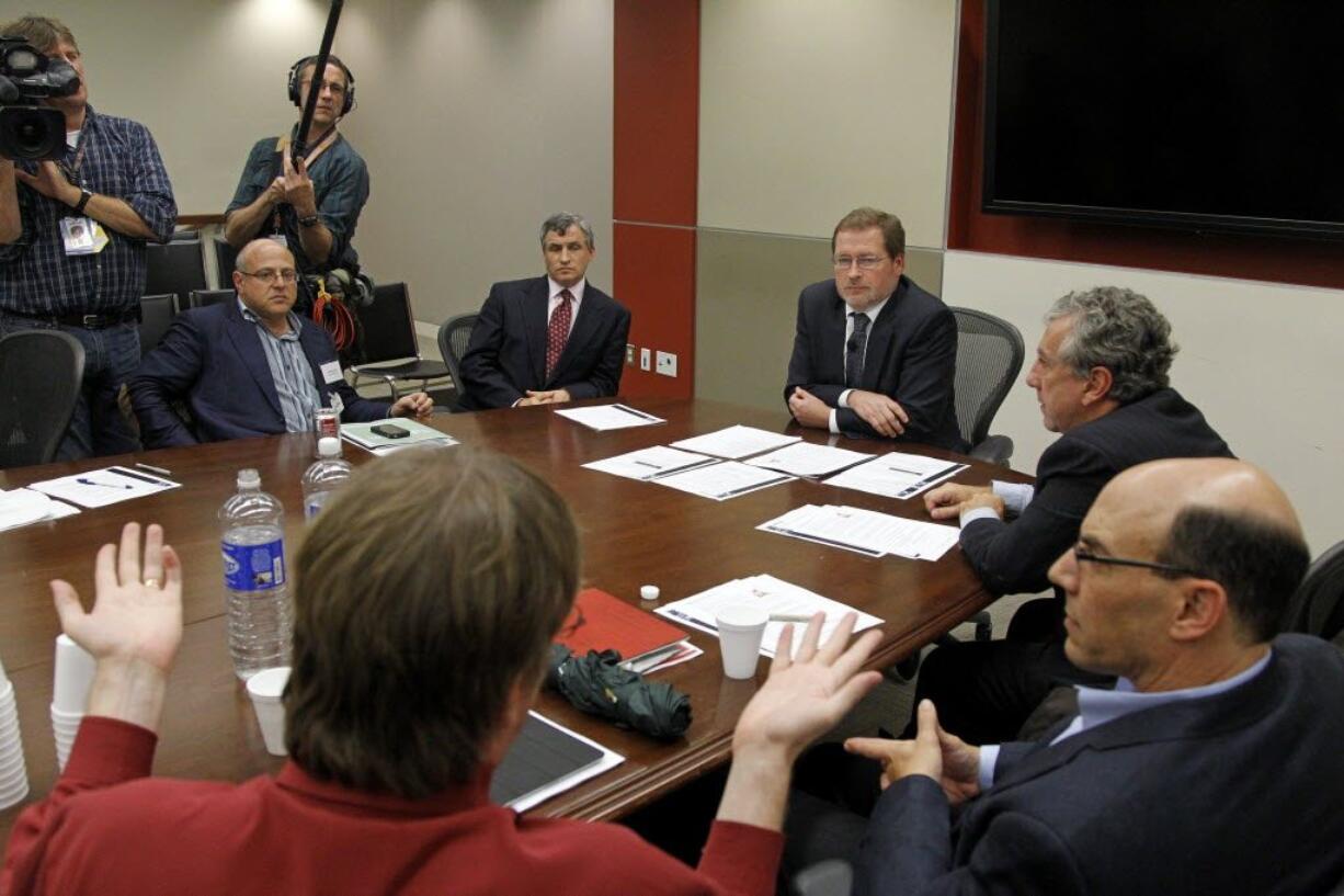 Grover Norquist, president of a taxpayer advocacy group, Americans for Tax Reform, center, meets with a group of millionaires to discuss issues related to the debt supercommittee on Wednesday in Washington.