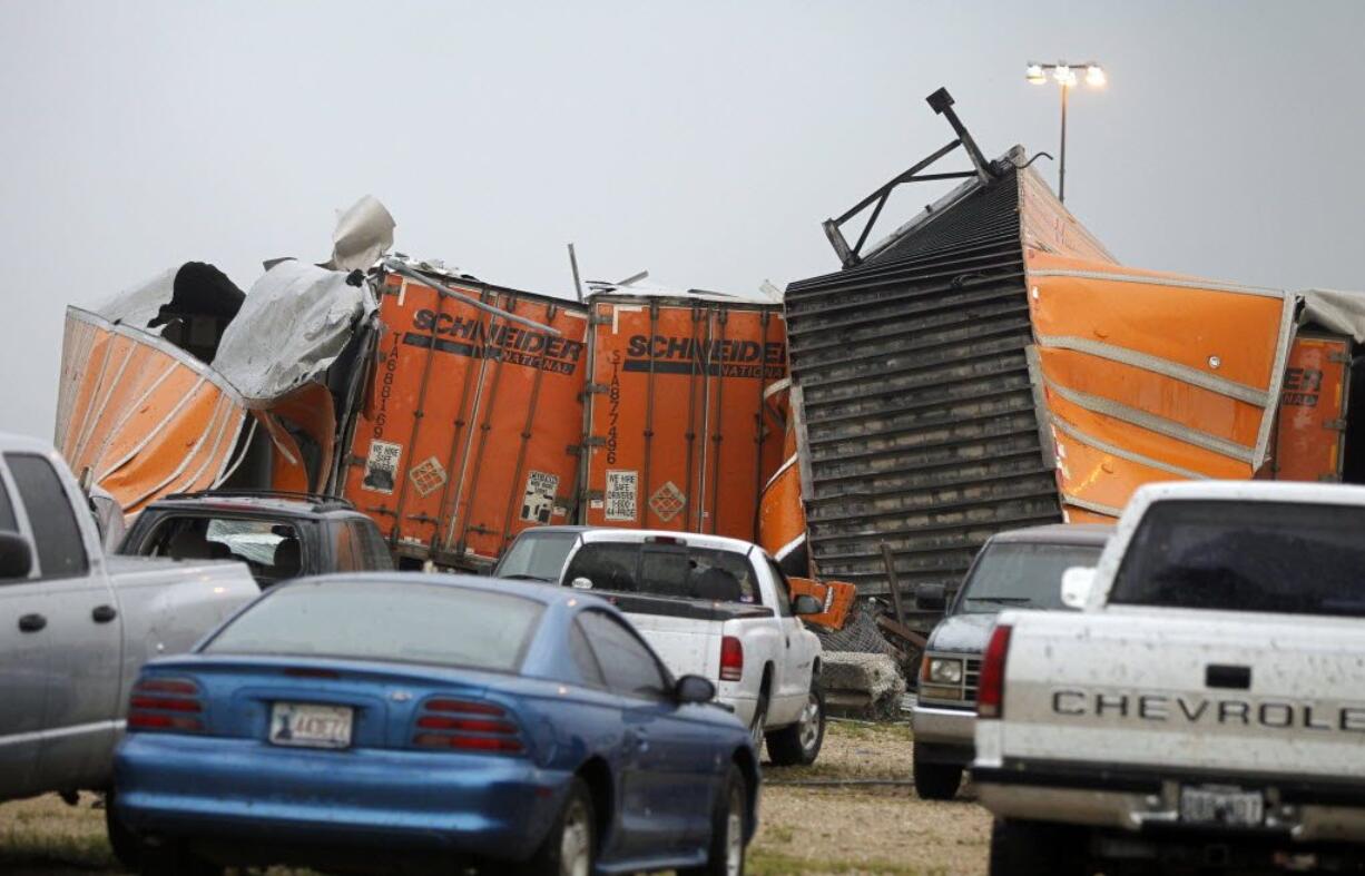 Trailers lay smashed atop one another after a tornado reportedly tore through the southeastern portion of Dallas County, Texas, Tuesday, near Lancaster, Texas.