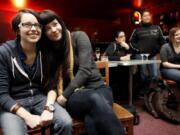 Elizabeth Scallon, left, and Shena Lee, listen to a toast Monday at the Wild Rose in Seattle celebrating Washington allowing same-sex couples to marry. Bars throughout Seattle and the rest of the state celebrated Gov. Chris Gregoire's signing of the bill legalizing gay-marriage earlier in the day.