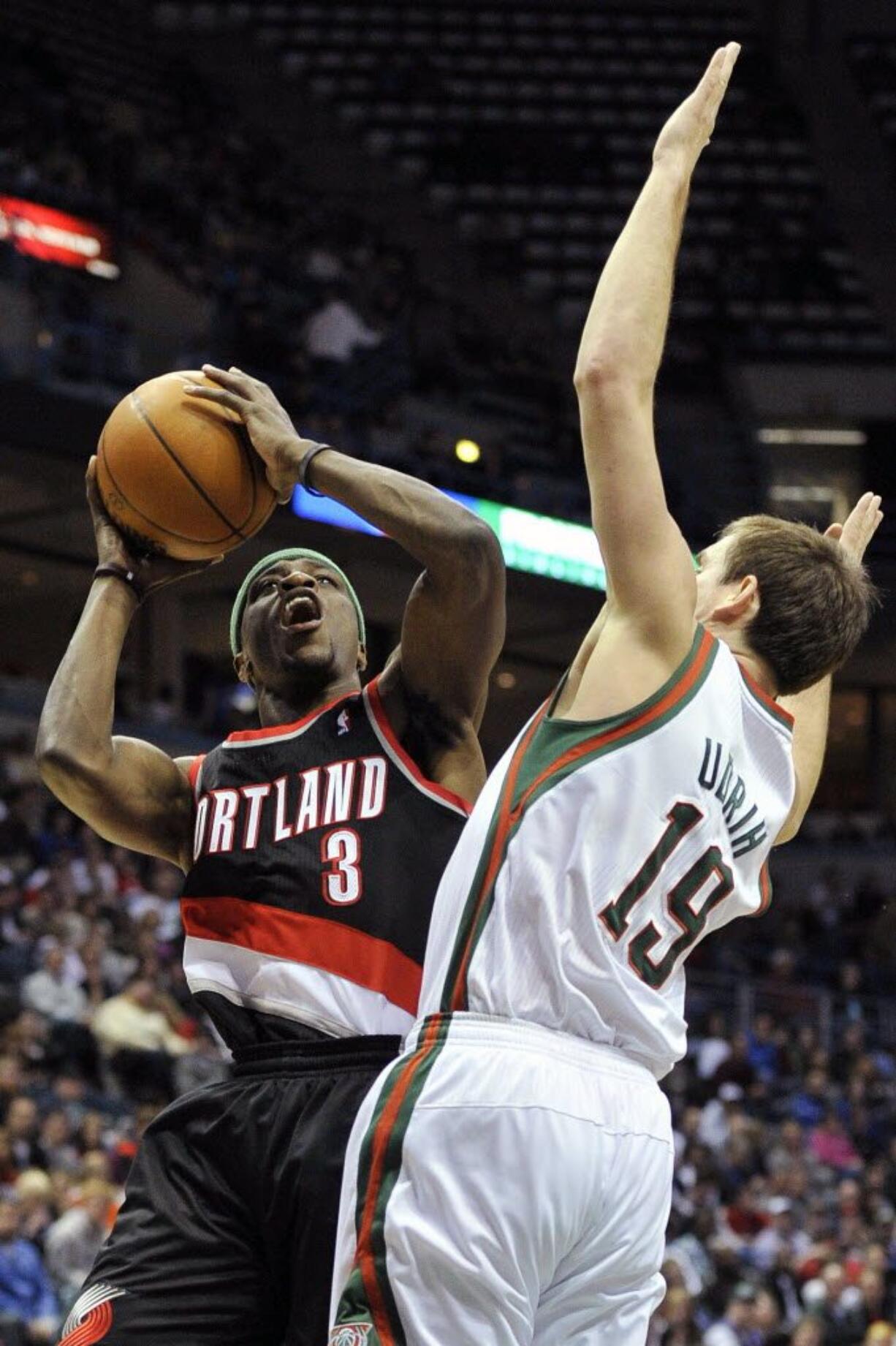 Portland Trail Blazers' Jonny Flynn (3) drives to the basket over Milwaukee Bucks' Beno Udrih (19) during the first half Saturday.