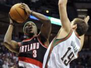 Portland Trail Blazers' Jonny Flynn (3) drives to the basket over Milwaukee Bucks' Beno Udrih (19) during the first half Saturday.