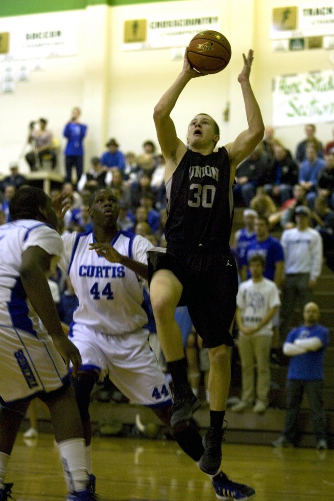 Union's Trent Cowan (30) goes to the basket past Curtis' Jaurence Chisolm (44) and Darius Johnson-Wilson.