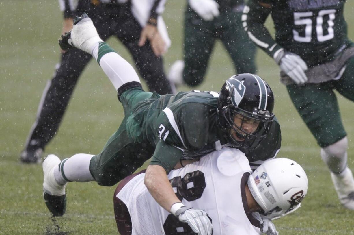 Portland State linebacker AJ Schlatter (31) tackles Montana wide receiver Ben Roberts.