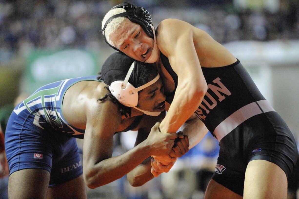 JoJo Reynolds, right, of Union High School, works to gain hand control over Lance Gibson of Todd Beamer High School in the boys 152-pound match at the WIAA state wrestling competition on Friday.