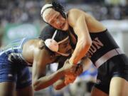 JoJo Reynolds, right, of Union High School, works to gain hand control over Lance Gibson of Todd Beamer High School in the boys 152-pound match at the WIAA state wrestling competition on Friday.