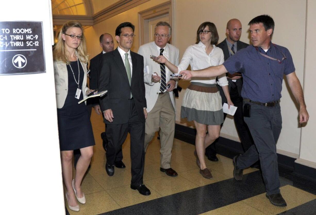 House Majority Leader Eric Cantor of Va., is followed by reporters as he walks out of a caucus meeting Friday on Capitol Hill in Washington.