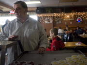 Bar Owner Chuck Chronis makes sure that all is going smoothly while he serves up a free Thanksgiving meal to those who need it at Chronis' Restaurant &amp; Lounge on November 25, 2010.