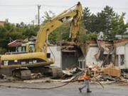 Construction crews and equipment began razing Vancouver's oldest Burgerville restaurant today.