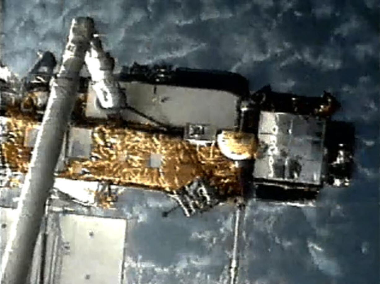 This screen grab image provided by NASA shows UARS attached to the robotic arm of the space shuttle Discovery during mission STS-48 in 1991, when UARS was deployed.