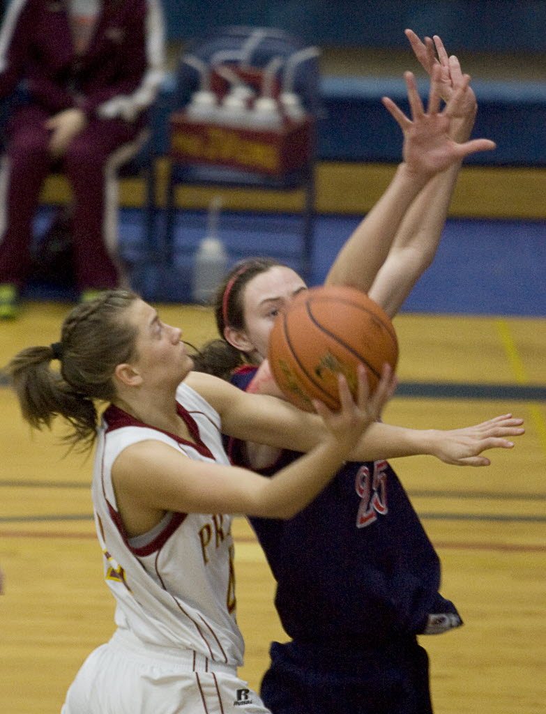 Prairie's Andrea Smith, left, is fouled by Juanita's Molly Grager going to the basket during Saturday's 3A regional playoff game at Rogers High School.