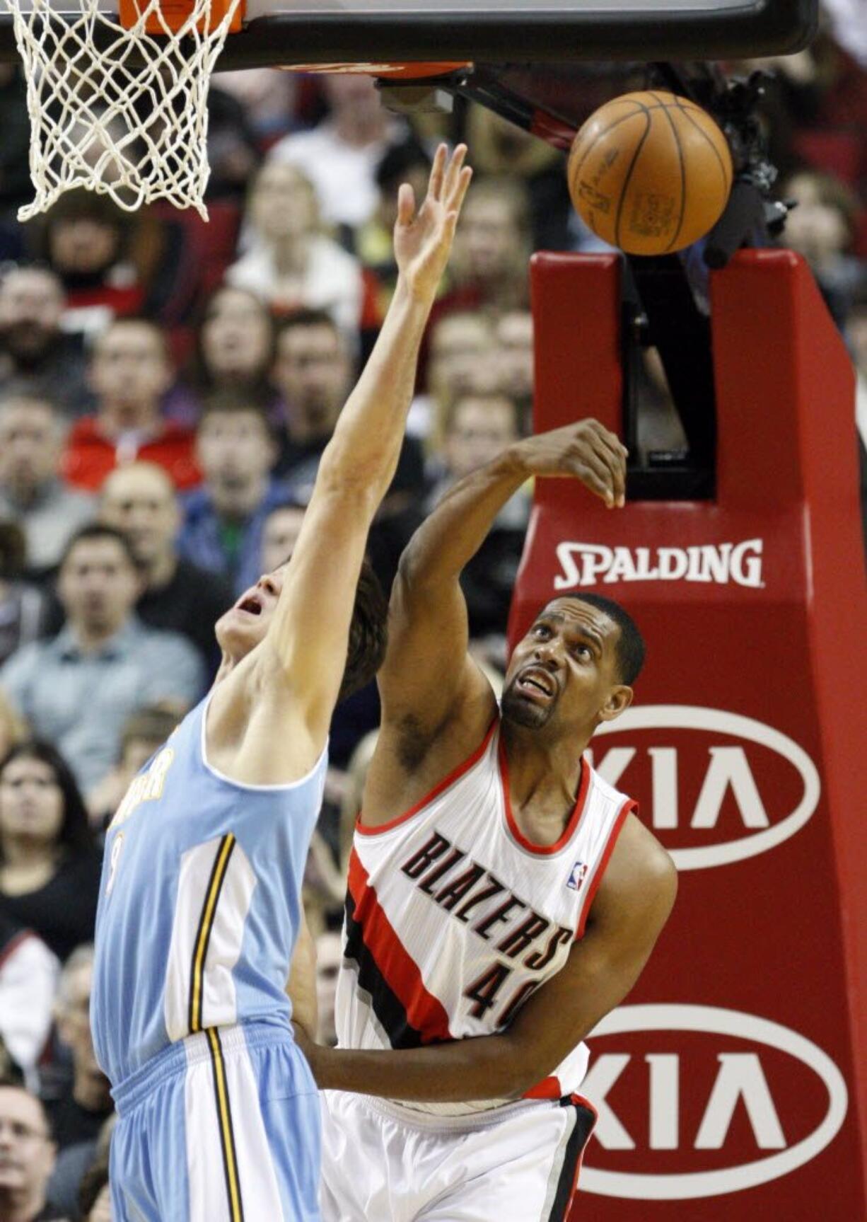 Portland's Kurt Thomas (40) may be known for his shooting, but he also battles for loose balls as well, like here against Denver's Danilo Gallinari.