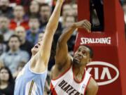 Portland's Kurt Thomas (40) may be known for his shooting, but he also battles for loose balls as well, like here against Denver's Danilo Gallinari.