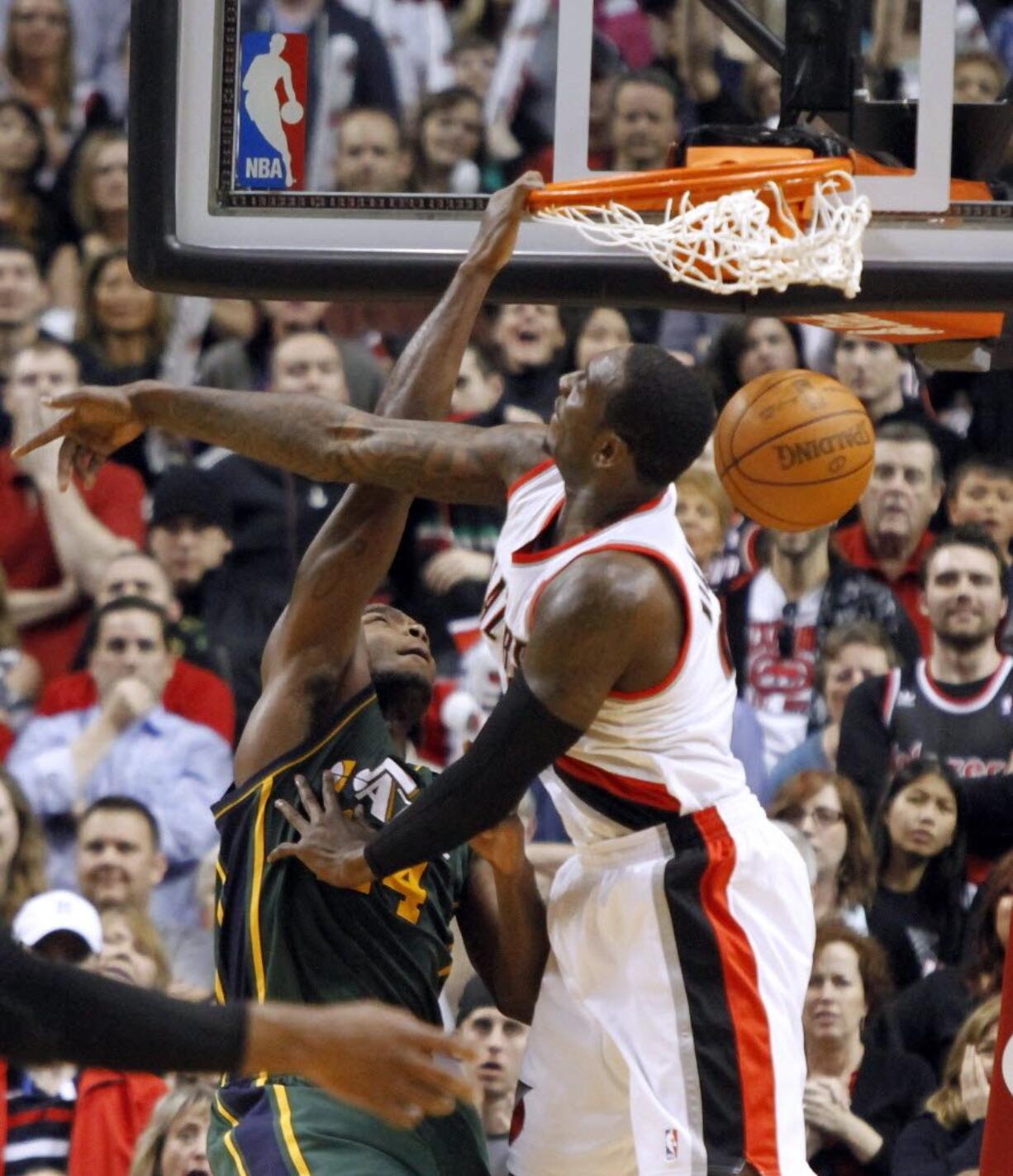 Utah Jazz forward Paul Milsap, left, dunks against Portland Trail Blazers forward J.J. Hickson during the second half Monday.