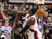 Utah Jazz forward Paul Milsap, left, dunks against Portland Trail Blazers forward J.J. Hickson during the second half Monday.