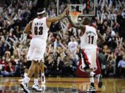 Jamal Crawford (11) gets a high-five from teammate Craig Smith after scoring during Monday's game against the Sacramento Kings.