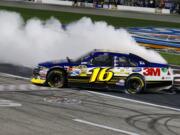 Greg Biffle (16) does a burnout as he celebrates his win Saturday at Texas Motor Speedway.