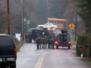 Regional SWAT team members gather near a home on Northeast 40th Avenue in Vancouver Thursday.