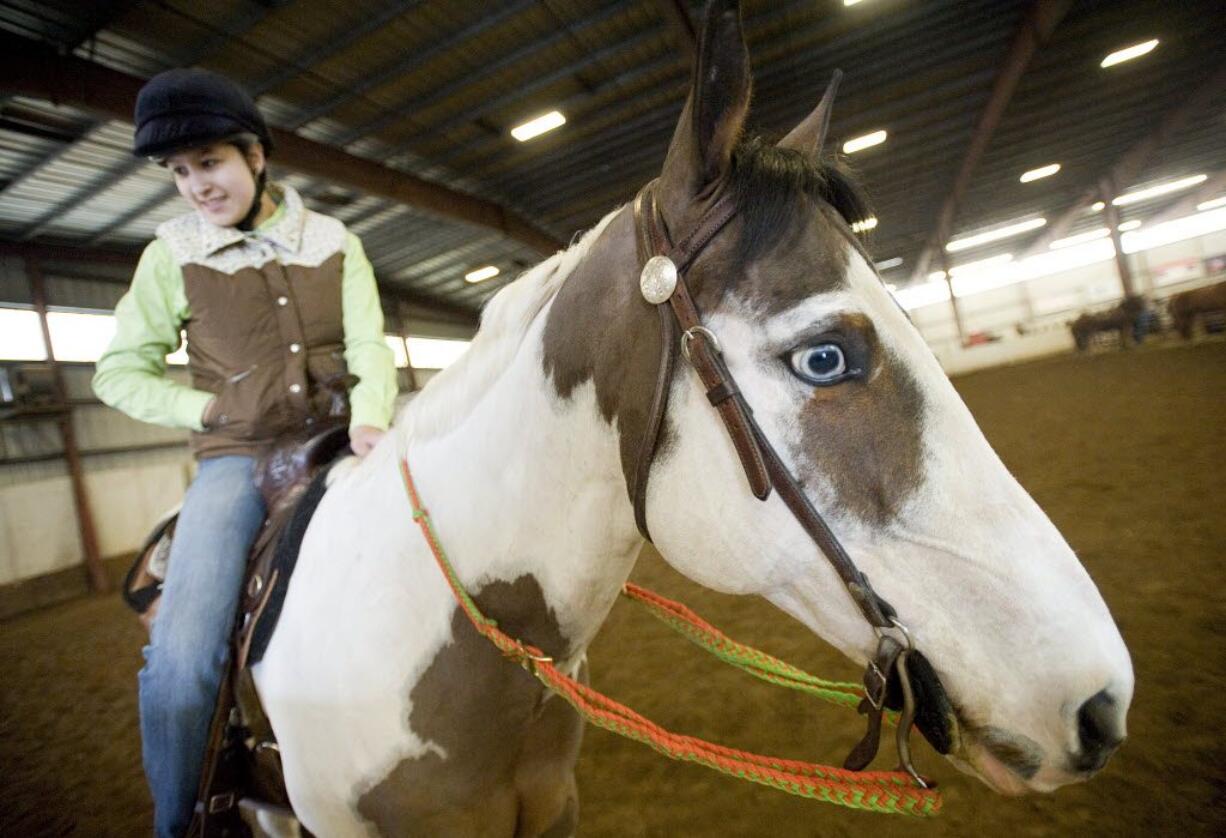 Amber Rios, 19, from Vancouver, competes Sunday in the Craig Cameron Extreme Cowboy Race at the Washington State Horse Expo, held at the Clark County Event Center at the Fairgrounds.