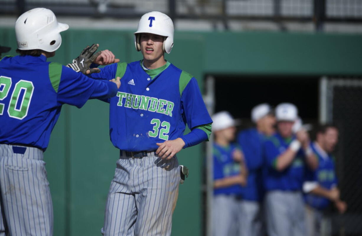 Mountain View's Dean Taylor, left, congratulates teammate Jake Shelley as he crosses home plate to make it 2-0 in the third inning against Camas on Thursday.