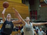 Skyview's Katie Swanson puts up a shot against Heritage High's Emily Myers in the second half of the Les Schwab Roundball Shootout at Prairie High School on Sunday March 25, 2012.