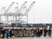 Protestors leave the Port of Oakland after successfully blocking the entrances, Monday in Oakland, Calif.