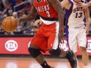 Portland's Jonny Flynn (3) looks to pass as Phoneix Suns' Steve Nash (13) pursues during the first half Monday.