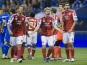 Portland Timbers' Jack Jewsbury (13), Steven Smith (14) and Eric Brunner (5) react after the referee awarded a penalty kick to the Montreal Impact during second half Saturday.