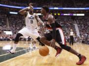 Portland Trail Blazers forward Gerald Wallace (3) drives past Utah Jazz forward Josh Howard (8) during the first half Monday.