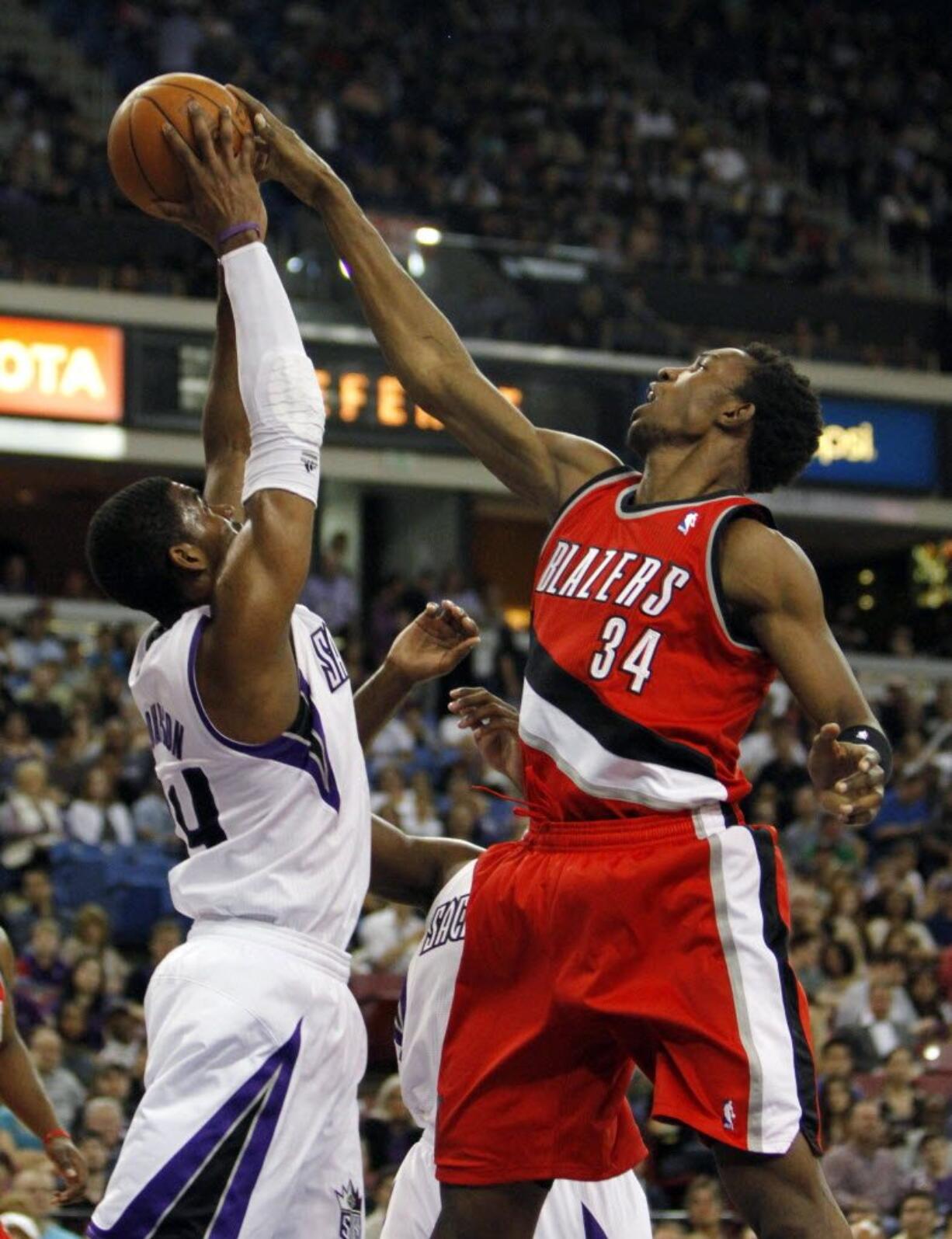 Sacramento Kings forward Jason Thompson, left, grabs a rebound away from Portland Trail Blazers center Hasheem Thabeet during the first quarter Sunday.