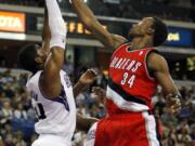 Sacramento Kings forward Jason Thompson, left, grabs a rebound away from Portland Trail Blazers center Hasheem Thabeet during the first quarter Sunday.