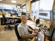 C-Tran dispatcher Leon Muffett communicates with bus drivers last week.