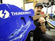 Marcus Young, co-owner and designer with Young Electric Guitars, shows off an instrument commissioned by Intel to showcase the tech firm's latest technology.