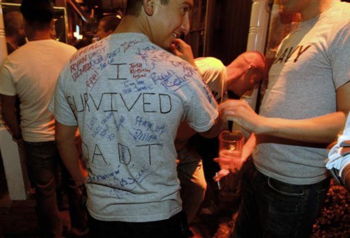 A man who is active-duty in the Navy, and only gave his name as Matt, wears a shirt being signed by others that reads &quot;I survived D.A.D.T.&quot; (don't ask, don't tell) shortly before midnight during a celebration for the end of the policy late Monday, Sept. 19, 2011, in a bar in San Diego. After years of debate and months of final preparations, the military can no longer prevent gays from serving openly in its ranks.