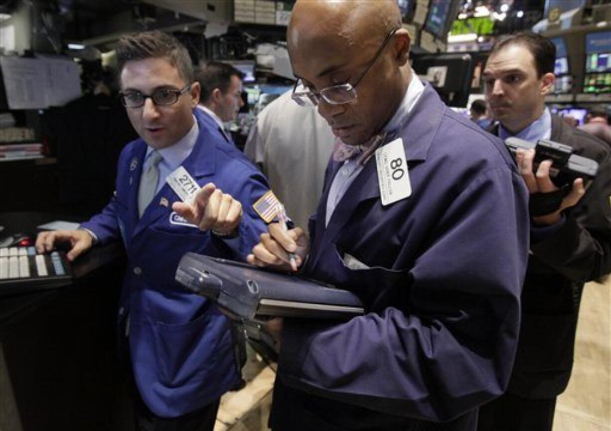 In this Aug. 18, 2011 photo, trader Lewis Vande Pallen, center, works on the floor of the New York Stock Exchange. Global stocks slid again Friday, Aug. 19, as fears of a possible U.S. recession combined with ongoing worries over Europe's debt crisis, which is stoking acute fears over the continent's banking sector.